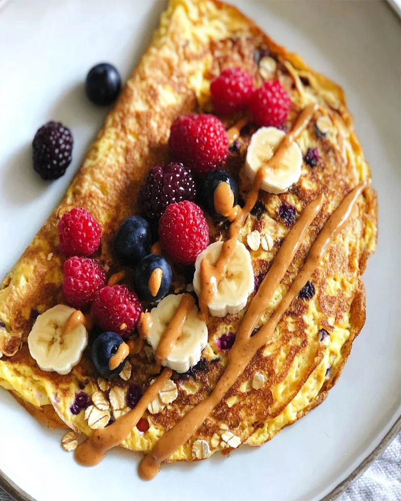 Sweet Banana Oat Omelet with Berries & Peanut Butter