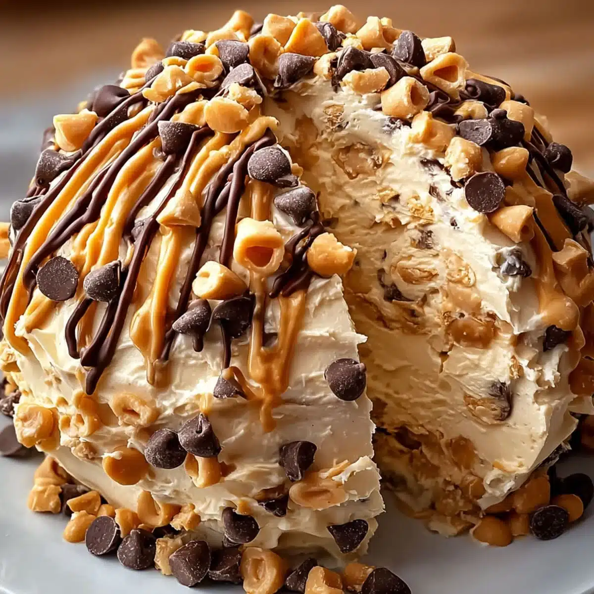 Reese’s Cheese Ball dessert with chocolate and peanut butter drizzle