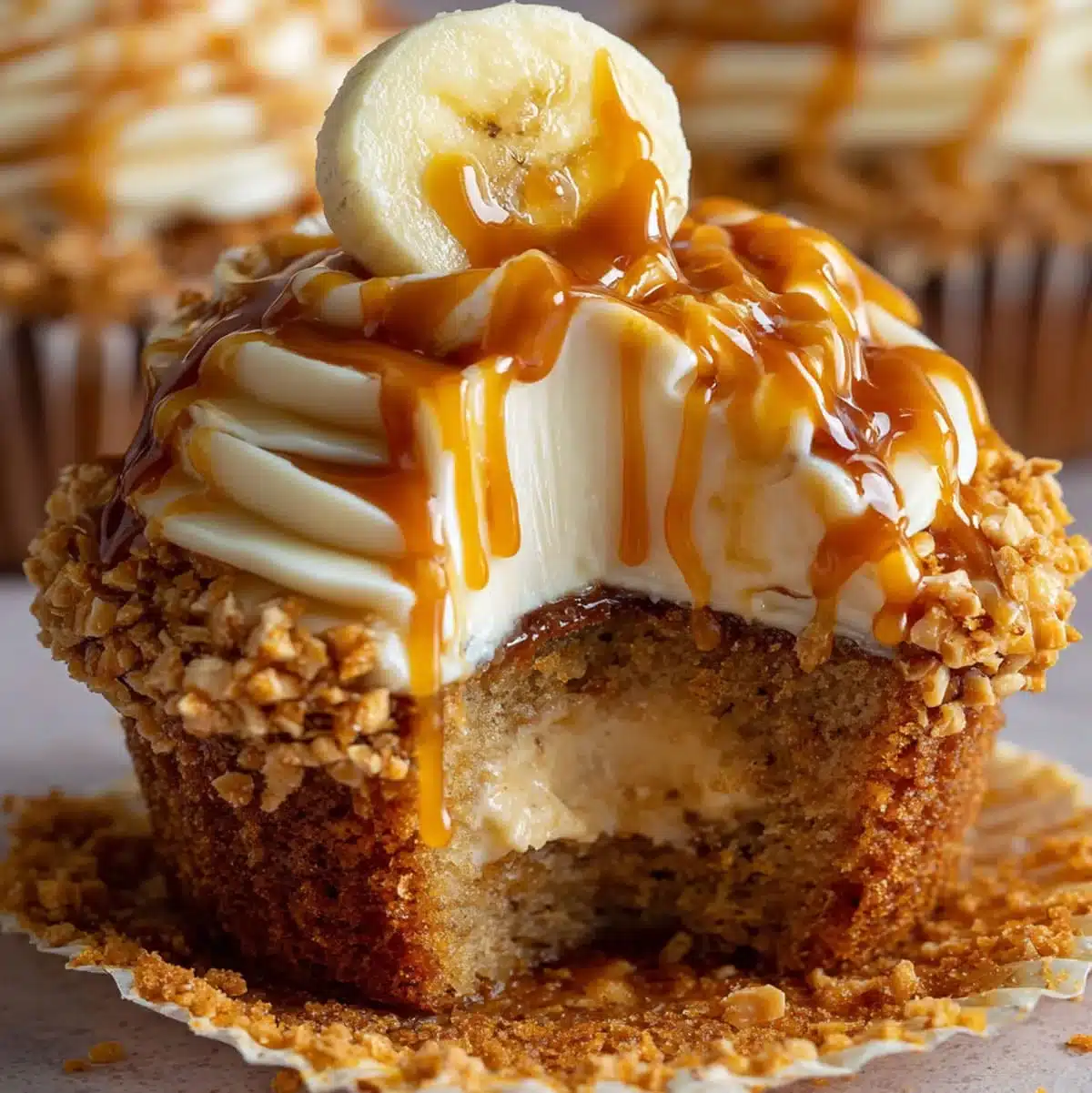 Banana cheesecake cupcakes with cream cheese frosting and caramel drizzle