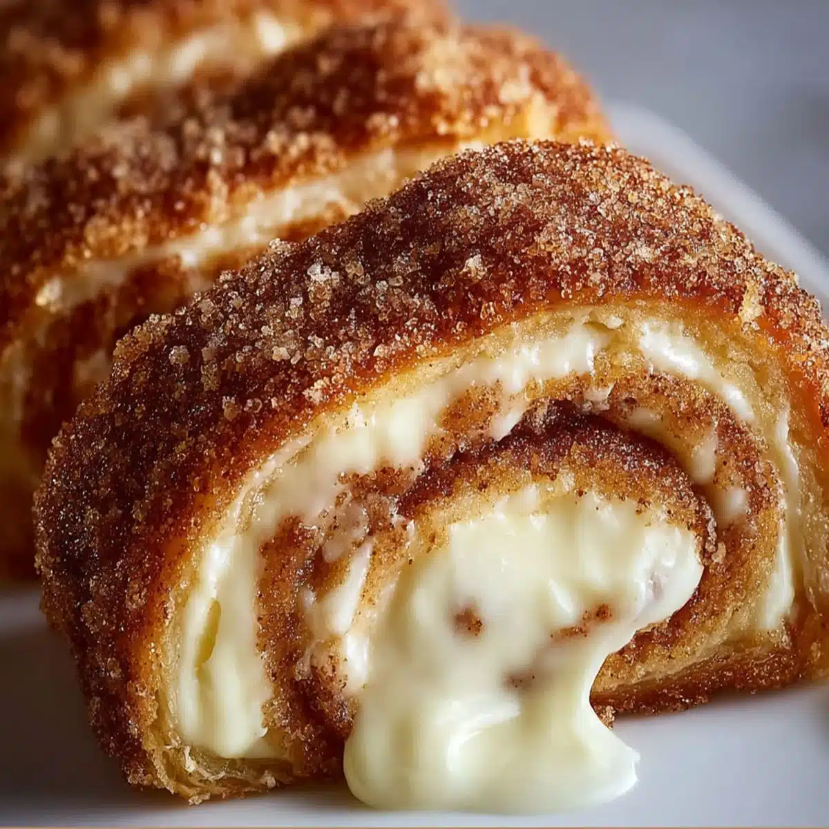 Cream cheese cinnamon sugar rolls with gooey filling and crispy cinnamon coating