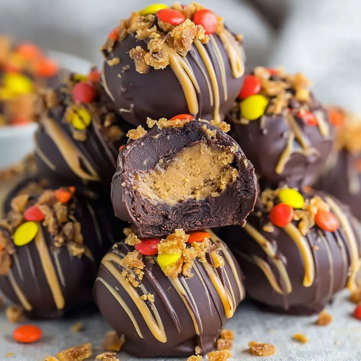 Chocolate peanut butter truffle with a creamy center and crunchy toppings