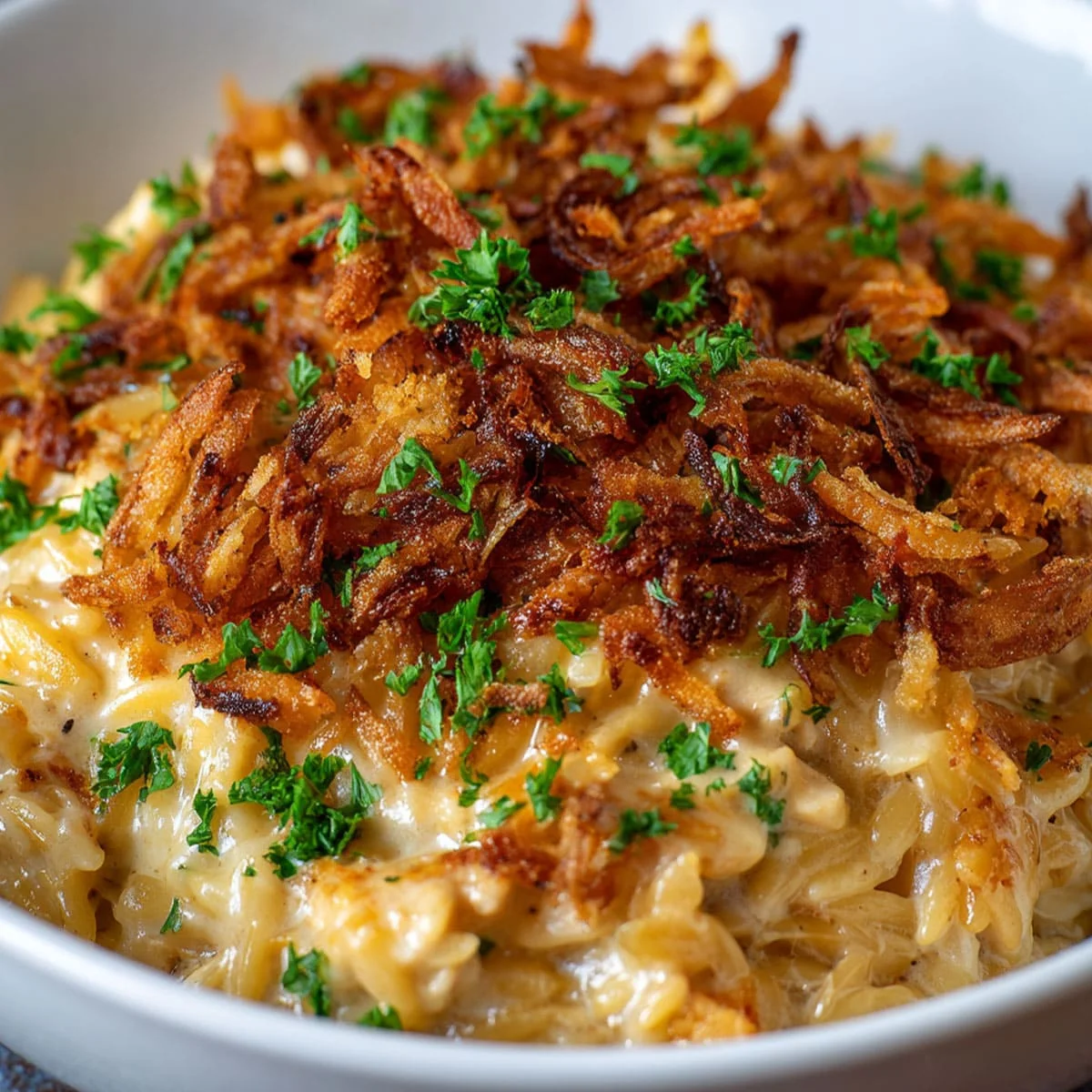 French Onion Chicken Orzo Casserole fresh from the oven with golden cheese crust and caramelized onions