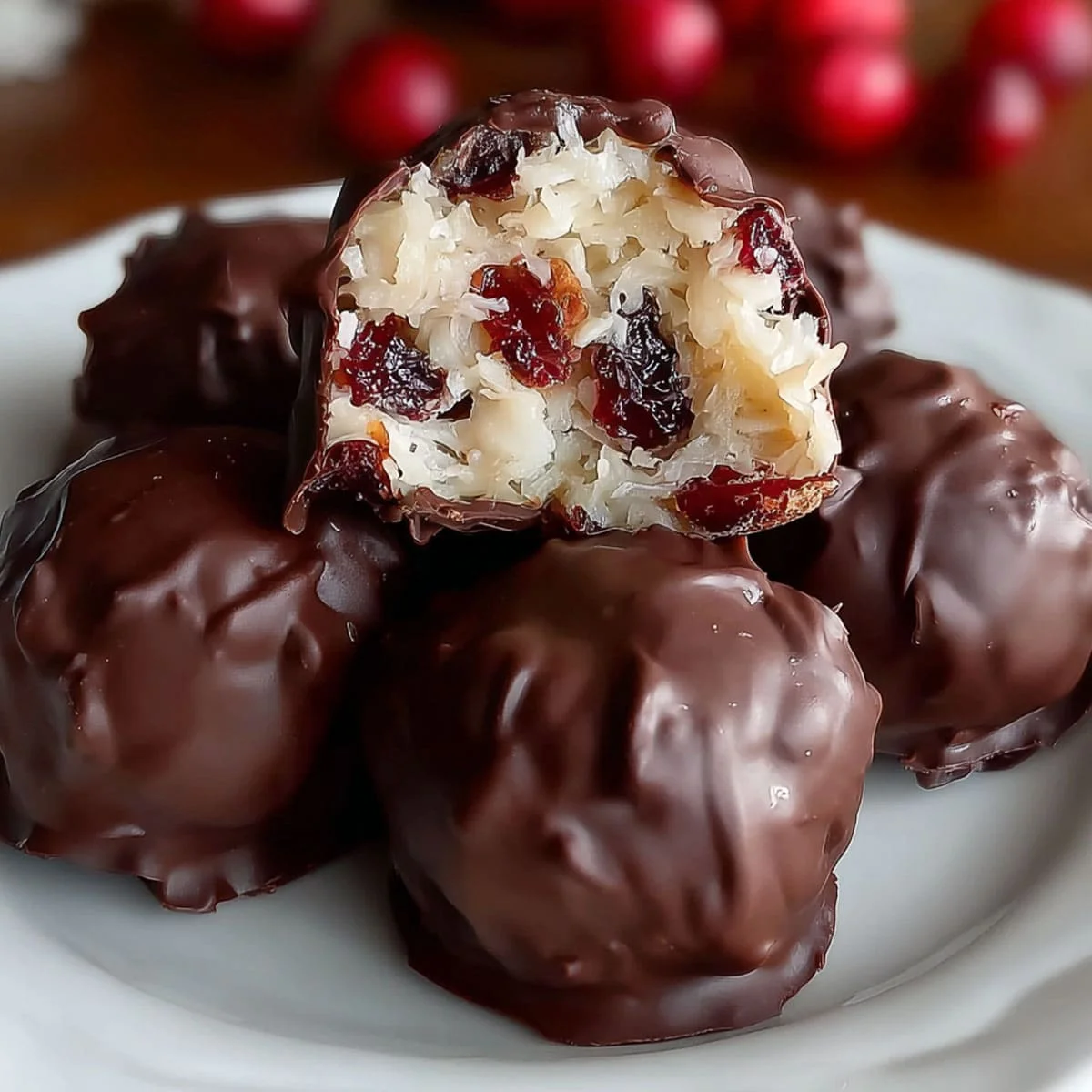 Old fashioned Martha Washington Candy 6 Close-up of homemade Martha Washington Candy showing the chewy coconut, pecan, and maraschino cherry filling inside a glossy dark chocolate coating.