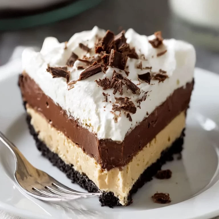 Creamy No Bake Peanut Butter Pie slice with chocolate pudding layer and whipped topping