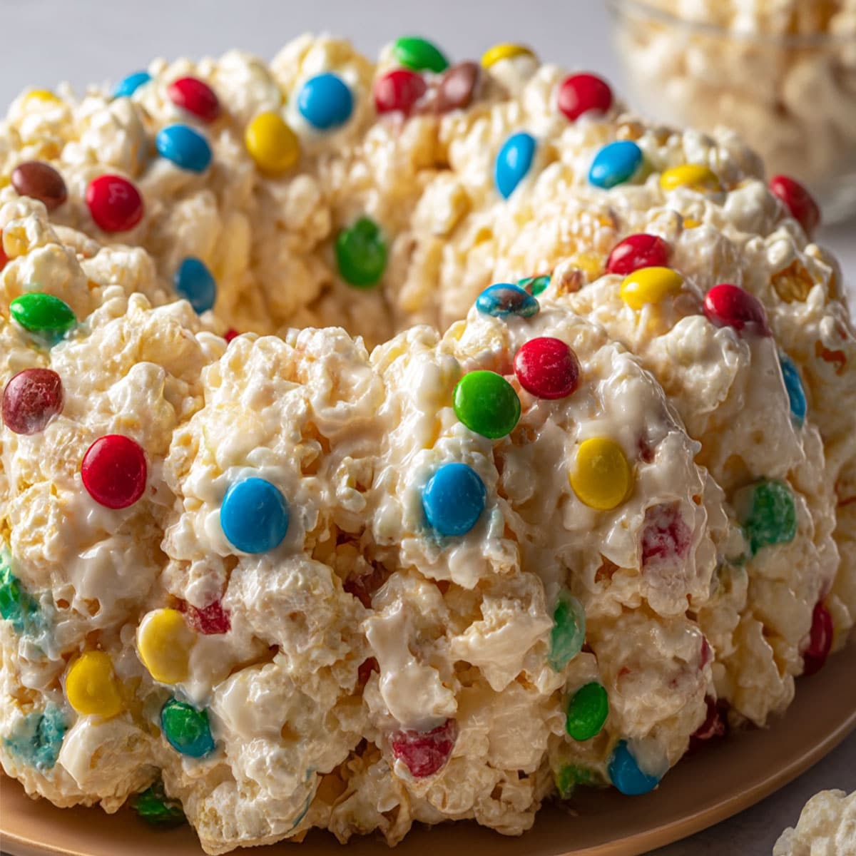 No bake Popcorn Cake topped with colorful candies and marshmallows