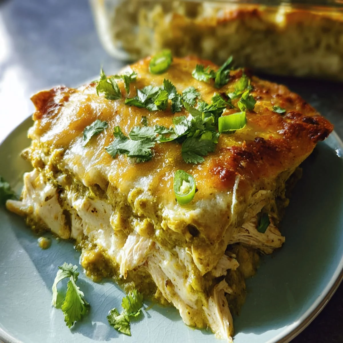 Green Chile Chicken Enchiladas served on a plate with cilantro topping