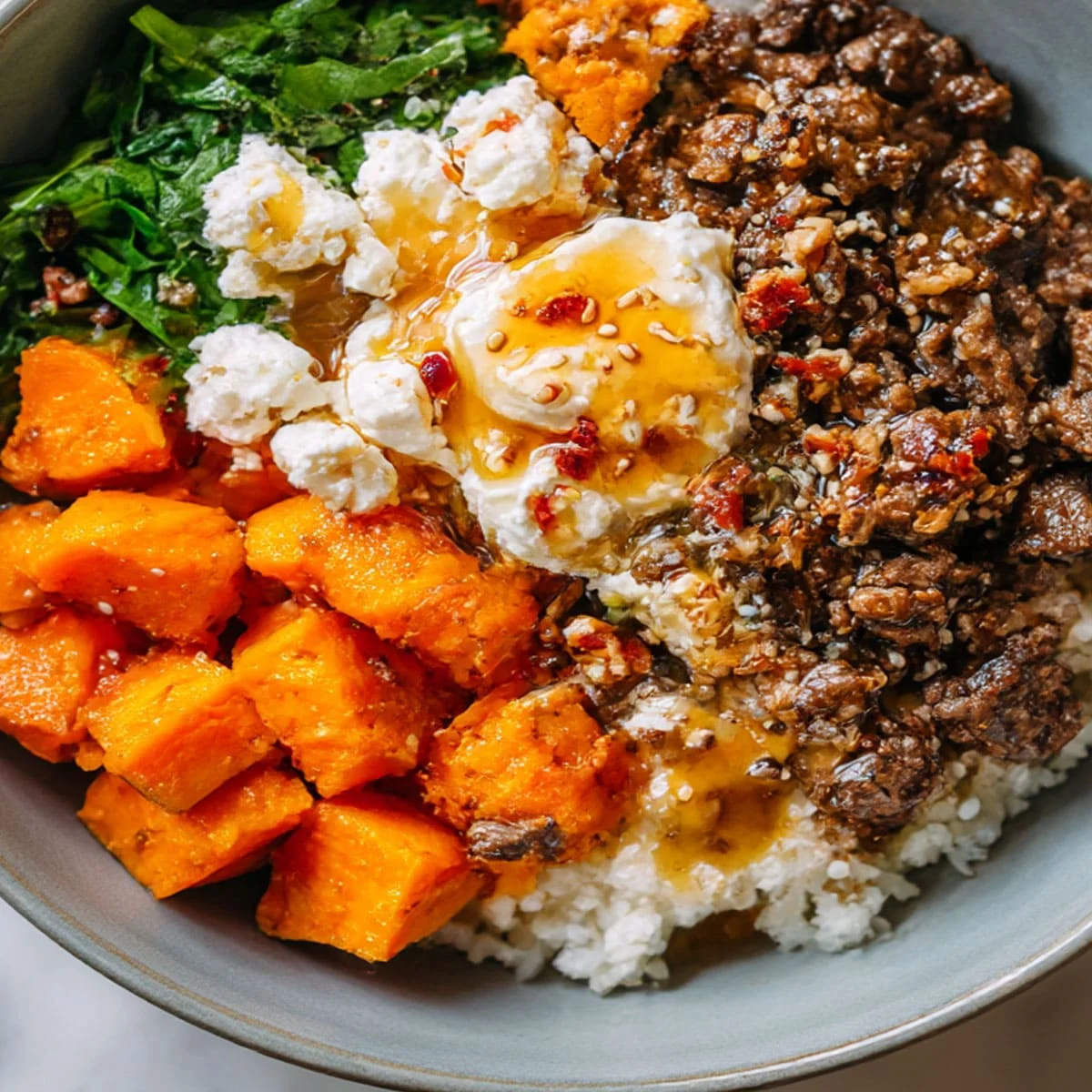 Close-up of Hot Honey Cottage Cheese Sweet Potato Beef Bowl with melted hot honey and creamy texture