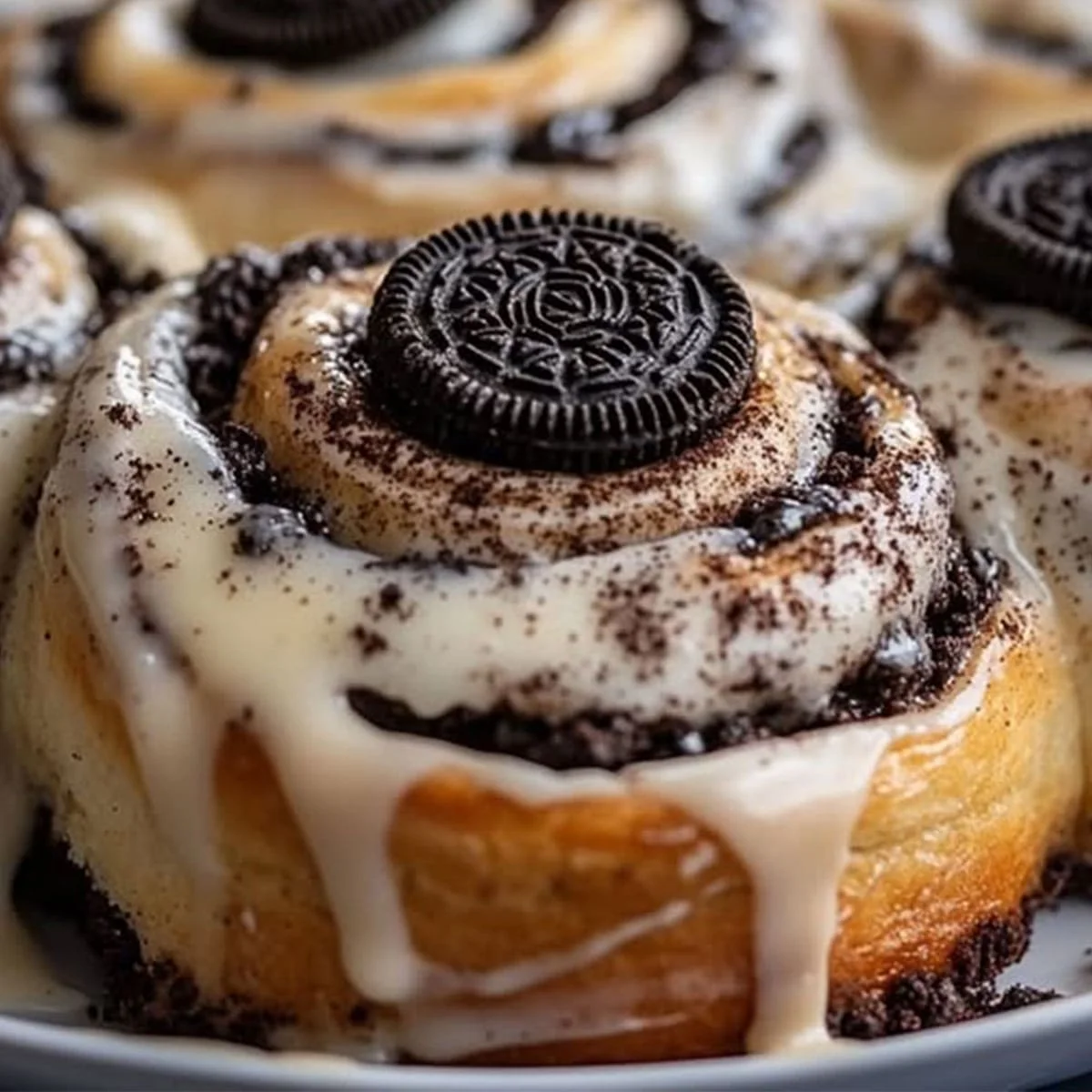 Oreo stuffed cinnamon rolls with soft spiral layers and creamy glaze