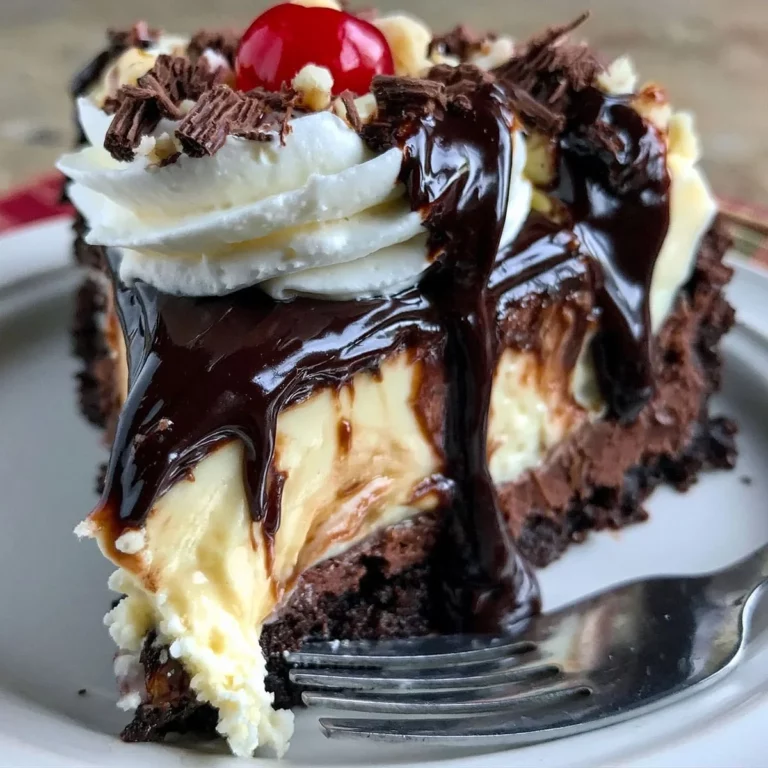 hot fudge sundae brownie cheesecake recipe with creamy cheesecake layer and rich chocolate fudge dripping over brownie base