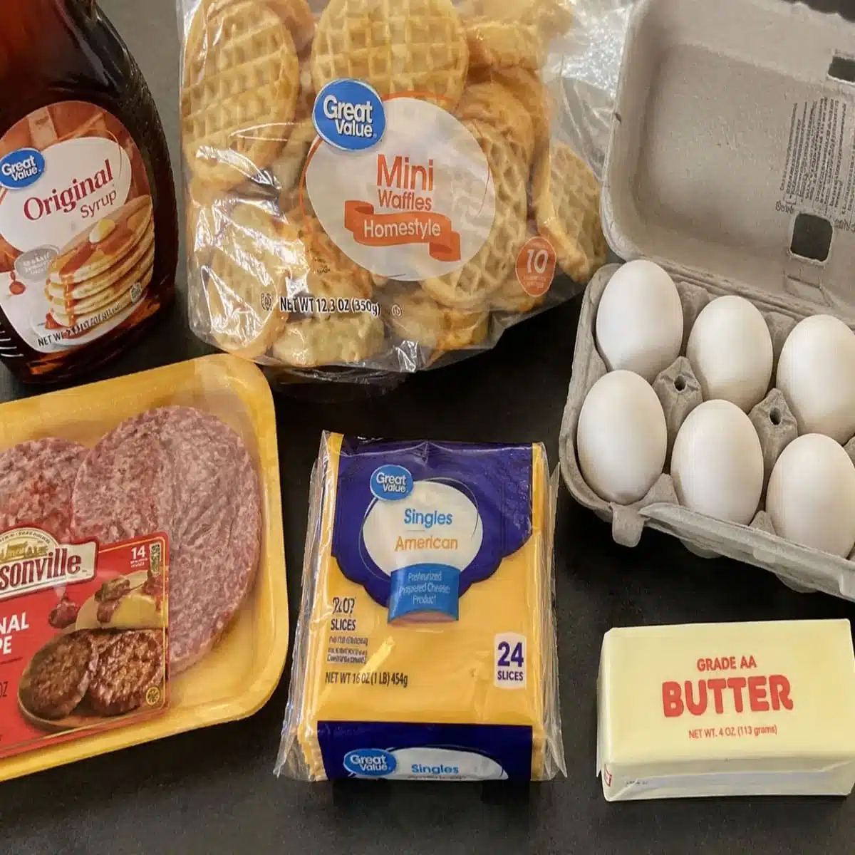 Waffle Sausage Egg & Cheese Sandwiches ingredients with mini waffles, eggs, sausage patties, American cheese, butter, and syrup.