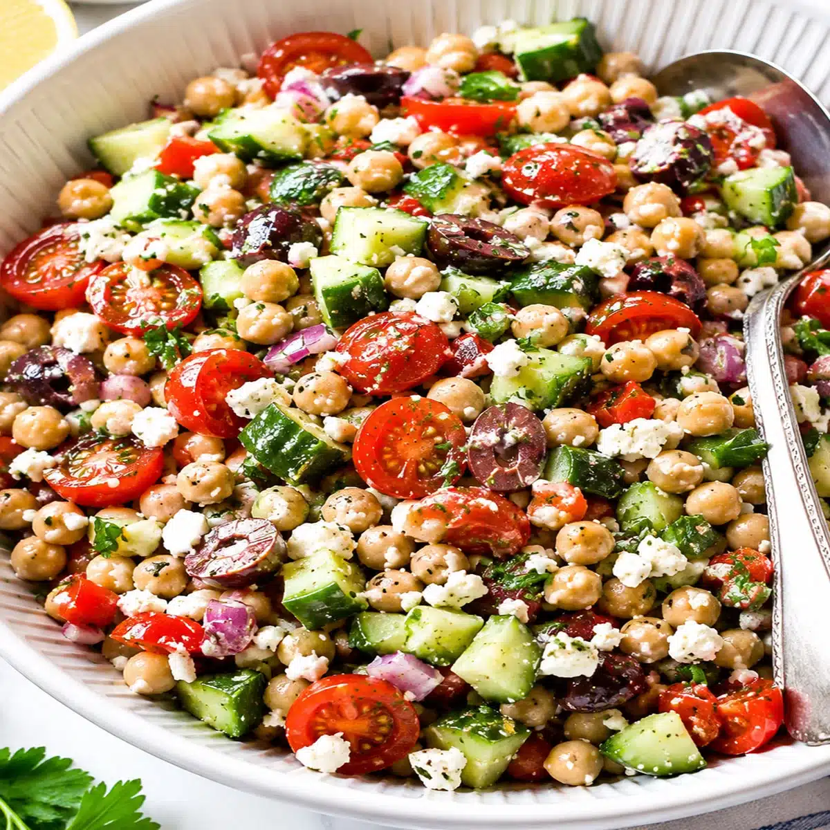 Mediterranean Chickpea Salad with chickpeas, cucumber, tomatoes, olives, feta, parsley, and zesty dressing