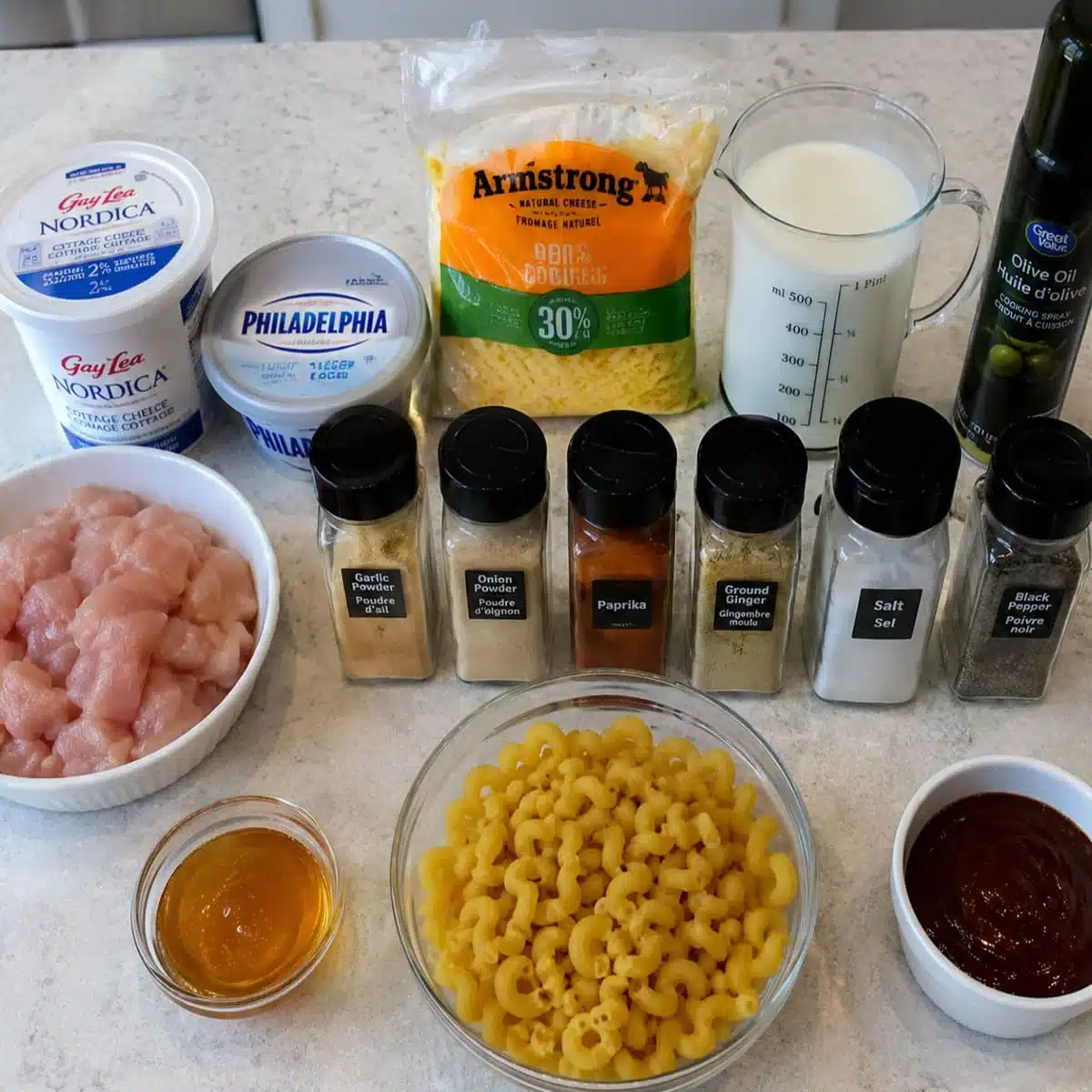 High Protein Honey BBQ Chicken Mac and Cheese Recipe 6 Honey BBQ Chicken Mac and Cheese ingredients with pasta, chicken, cheese, milk, honey, BBQ sauce, and seasonings